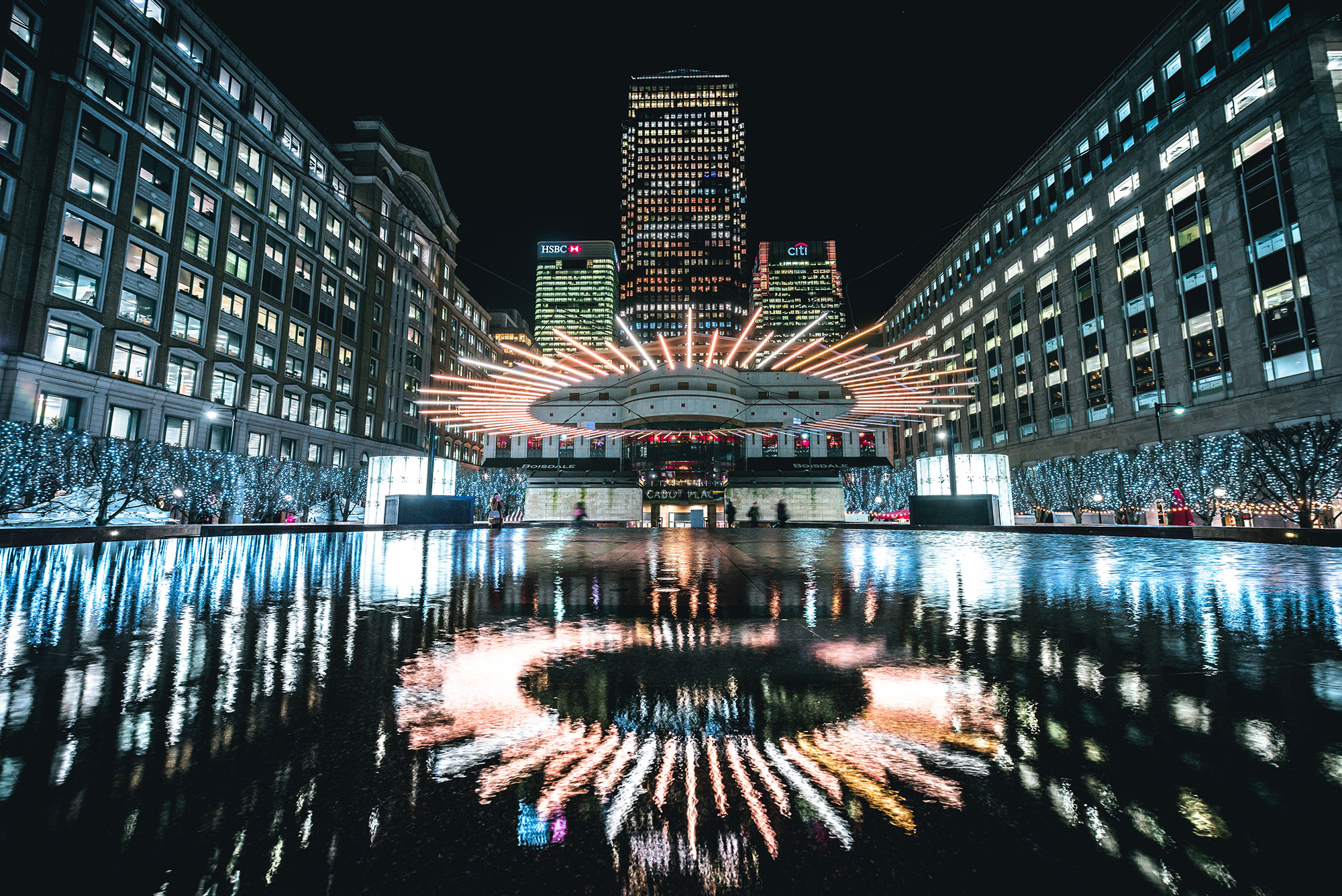 View of lights reflecting on water in Canary Wharf